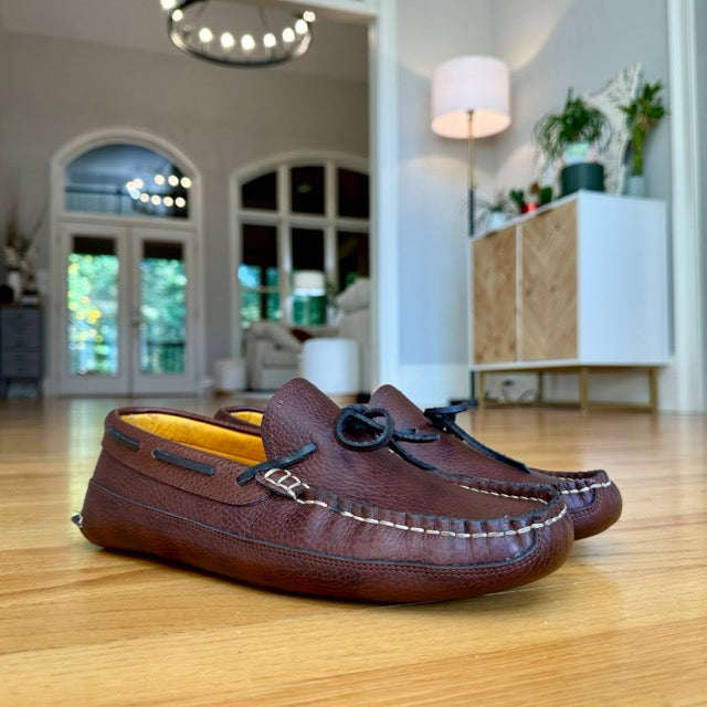 Blair's dark brown moccasins worn indoors