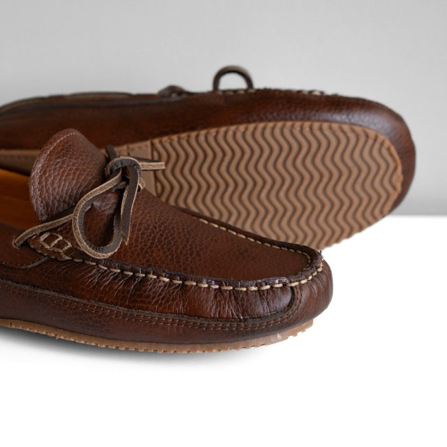 Brown leather loafers on a white background