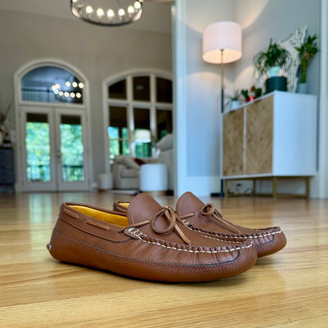 Harrison's honey brown moccasins worn indoors