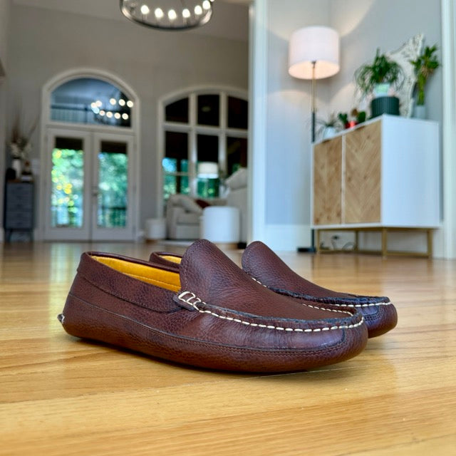 Mike's dark brown moccasins worn indoors