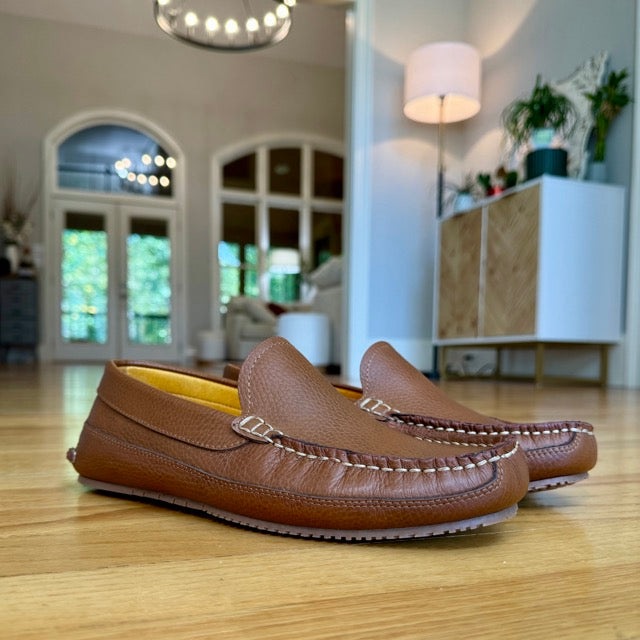 Sam's brown moccasins worn indoors